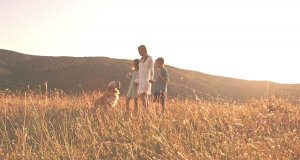 Mom, Kids and Dog out in Sunny Field